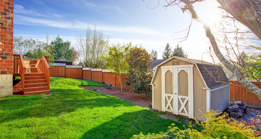 Fenced backyard with storage shed in Buffalo